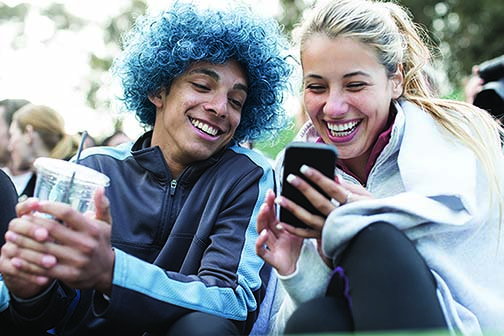 Young couple looking at a mobile phone and smiling