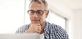 Middle-aged man looking away in thought.